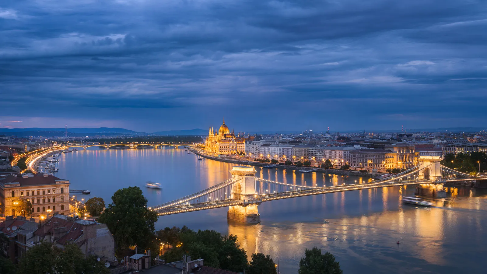 A spectacular view of Budapest at blue hour. The Hungarian Parliament and the Chain Bridge are the best illuminated landmarks in the city.