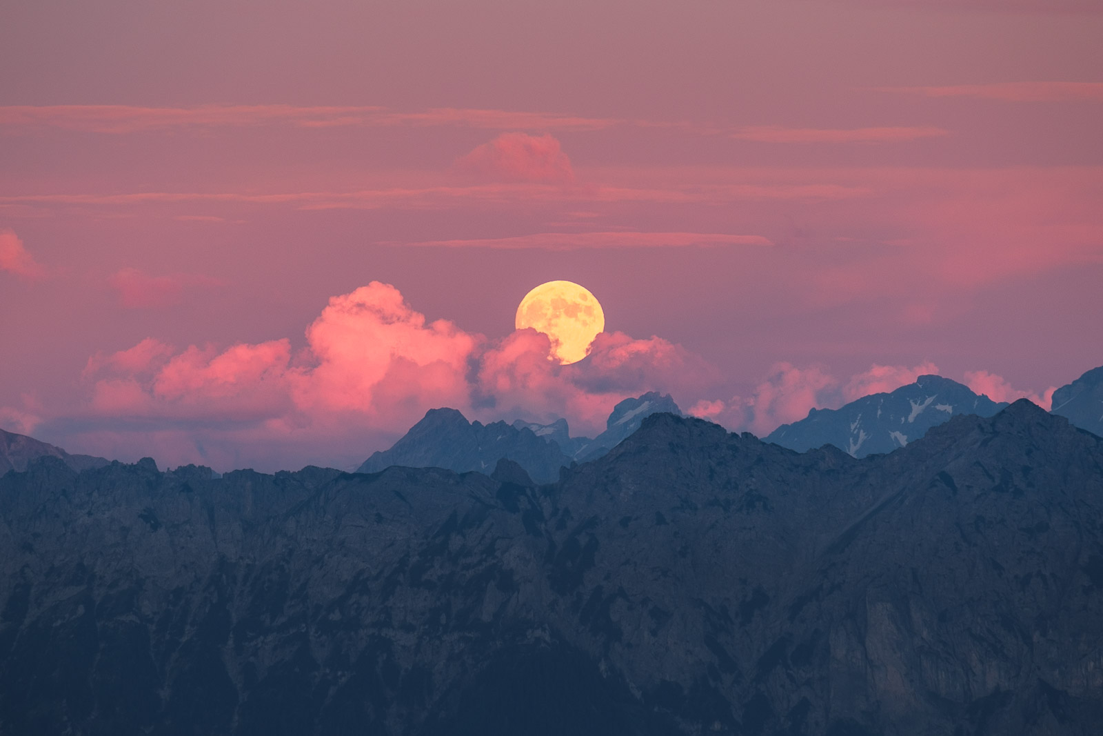 Full moon rising above the Alps of Austria