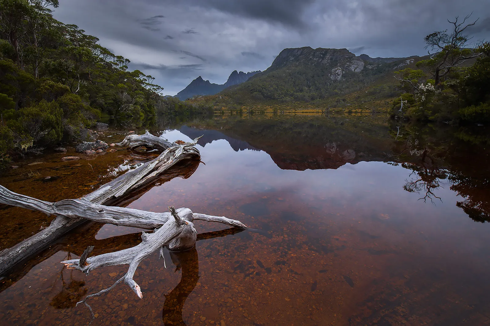 The iconic Cradle Mountain in Tasmania reflected in Wombat Pool, one of several lakes in Cradle Mountain-Lake St Clair National Park.