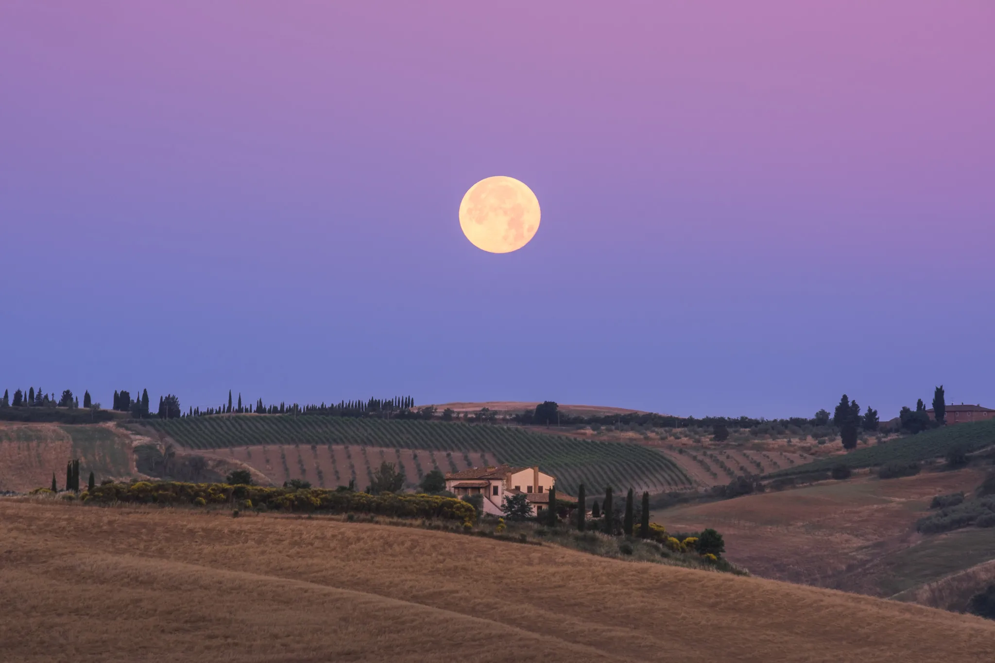 Full moon above a Tuscan landscape